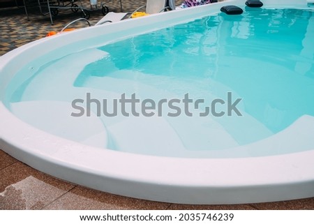 Fiberglass pool in the hotel courtyard. The pool is filled with clean clear water Royalty-Free Stock Photo #2035746239