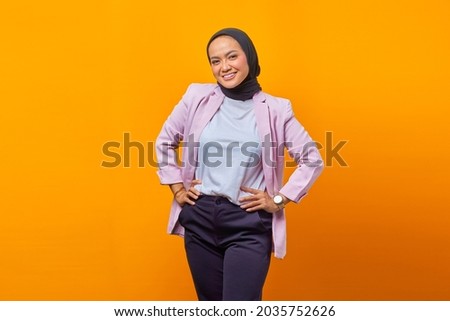 Beautiful asian woman smiling and looking ahead over blue background