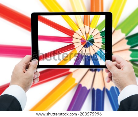 Businessman hands tablet taking pictures close up color pencils on a white background