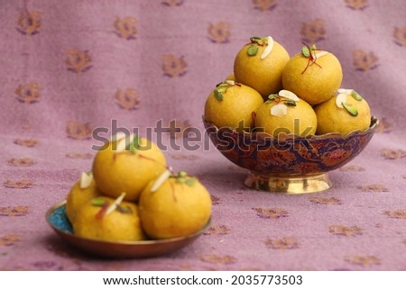 happy ganesha festival, Besan laddu with dry fruits in a brass bowl on a cloth background, landscape image, focus on a laddu, Royalty-Free Stock Photo #2035773503