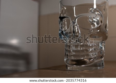Empty glass cup in the shape of a skull