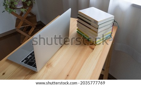 Books and laptops on the table.
