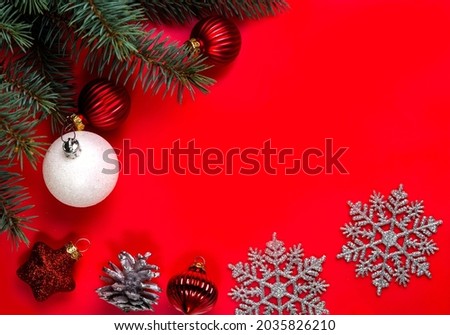 Christmas decorations lying on a red background. Copy space.