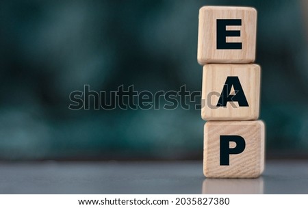 EAP (Employee Assistance Program) - acronym on wooden cubes on a blurr gray background. Internet concept Royalty-Free Stock Photo #2035827380