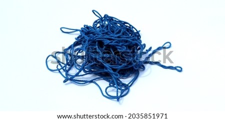 Blue knitting yarn on a white background. Chaotic blue threads into an irregular circle on a white background Royalty-Free Stock Photo #2035851971
