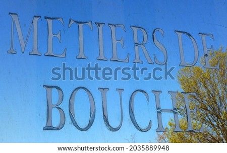 Window of an old restaurant with letters writing Catering Trades