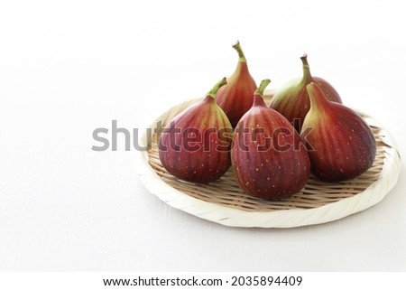 Fresh ripe figs on bamboo colander 