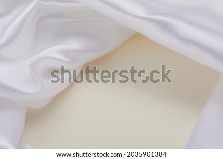 white silk texture on the  beige background