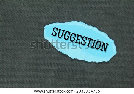 torn blue paper with the word suggestion. Business concept