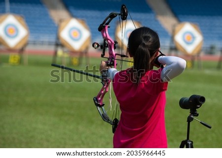 Little girl shoot at archery competition Royalty-Free Stock Photo #2035966445