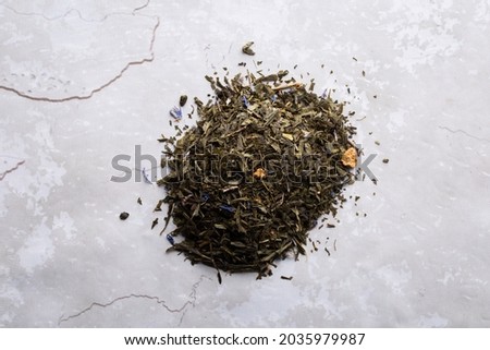 red berries with flavored black tea on a marble-like concrete grey floor.Top view.High resolution.