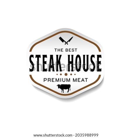 Vintage Retro Steak House Logo Design. With crossed cleavers or knives, and cow icons. Premium and luxury label or sticker