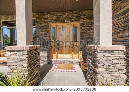 Entrance exterior of a house with stone veneer siding Royalty-Free Stock Photo #2035992188