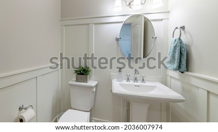 Pano Interior of a powder room with half wooden panel and lights Royalty-Free Stock Photo #2036007974