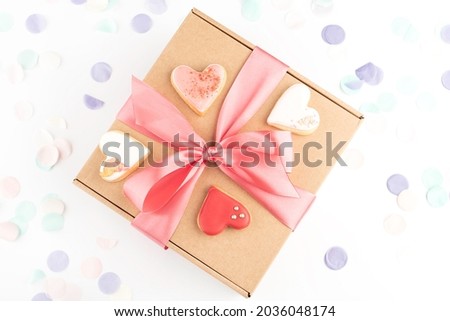 festive handcraft gift present box and heart shaped colorful cookies biscuits for Valentines's Day, Women's Day celebration. Top view