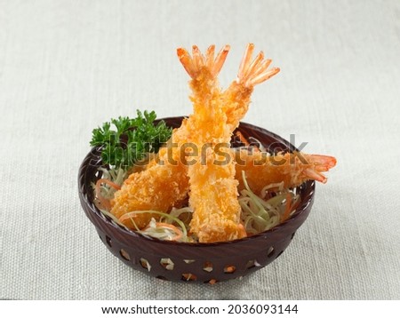Crispy Breaded Prawns, Panko breaded deep-fried shrimp or Ebi Furai Japanese food in basket on white canvas background. Royalty-Free Stock Photo #2036093144