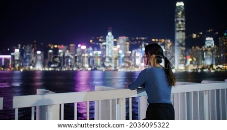 Woman look at the Hong Kong city night view