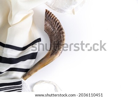 Shofar (horn) and tallit on a white background. Traditional symbol of the Jewish holiday. Top view Royalty-Free Stock Photo #2036110451