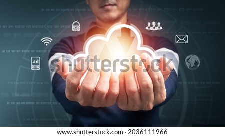 The concept is A Big data analytics and business intelligence with graph chart icons, cloud computing on a digital versual screen interface, and a man in the background blur.