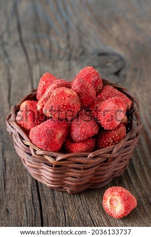 Dried strawberries on a wooden background.