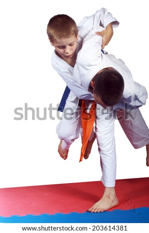 Athlete with orange belt is doing judo throw  Royalty-Free Stock Photo #203614381