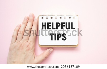 Expert showing a card with Helpful Tips written on it - Education concept
