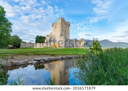 Ross Castles on edge and reflected in Killarney's lower lake in National Park in County Kerry, Ireland. Royalty-Free Stock Photo #2036171879