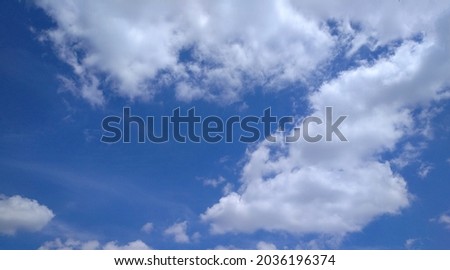 blue sky with thick white clouds