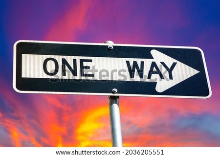 One way sign against sunset sky in New York City, NY, USA