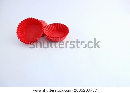 red paper cup mini for cake. white paper background isolated. space for text.