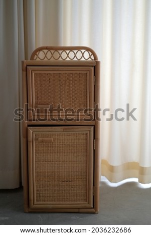 cabinet from brown rattan for clothes storage media and others

