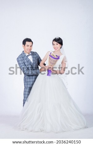 portrait of handsome groom hug beautiful bride on wedding day on isolated white background