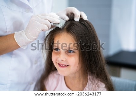 Child Doctor Checking Head Hair For Lice
