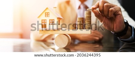 House Model Balance Equilibrium Concept. Real Estate Money Royalty-Free Stock Photo #2036244395