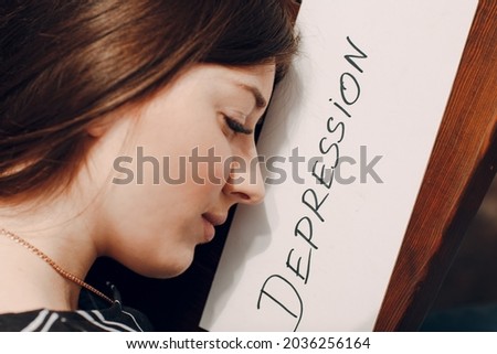 Woman profile portrait with white sheet paper labeled word Depression. Hidden depression concept.