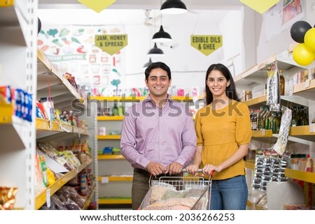 Portrait of indian couple at grocery store while shopping.
 Royalty-Free Stock Photo #2036266253