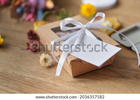 dried flowers, aromatic sachets made by hand. Autumn composition on a wooden table. Gift Box with, postcard layout with copy space for text.