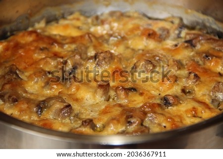 Cooking chicken julienne with mushrooms and cheese