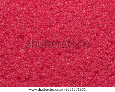 close-up, background, texture, large horizontal banner. heterogeneous surface fine pore structure bright saturated red pumice stone for finger care. full depth of field. high resolution photo