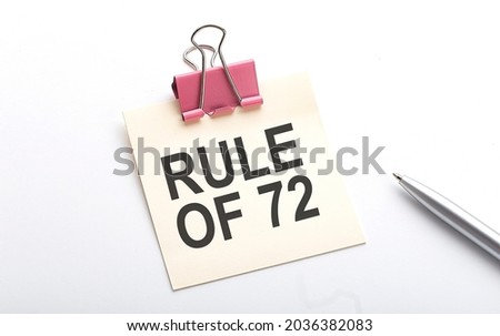 RULE OF 72 text on sticker with pen on the white background,business Royalty-Free Stock Photo #2036382083