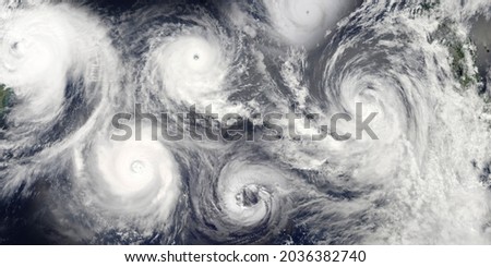 Hurricane season. Collage of a riot of hurricanes due to catastrophic climate change. Satellite view. Elements of this image furnished by NASA. Royalty-Free Stock Photo #2036382740