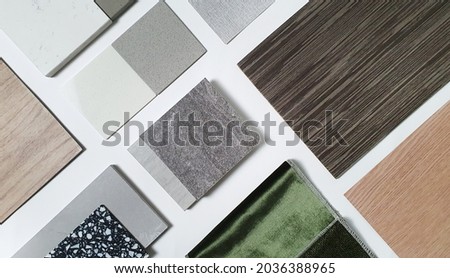 samples of interior material consists concrete tile, wooden laminated or veneer, artificial stones, green fabric for drapery, wooden vinyl flooring. interior selected material for mood and tone board. Royalty-Free Stock Photo #2036388965