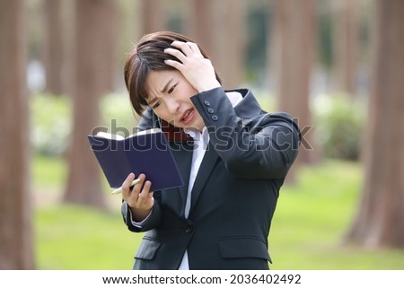 A woman having a headache in adjusting the schedule