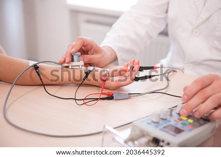 Patient nerves testing using electromyography at medical center Royalty-Free Stock Photo #2036445392