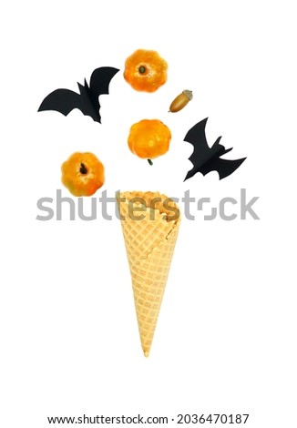 Ice cream cone with autumn pumpkins. Halloween minimal concept.