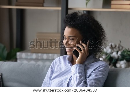 Phone call. Smiling black millennial female agent manager realtor talk on cell counsel advice customer on distance. Happy young afro american lady hold smartphone at ear listen to caller. Copy space Royalty-Free Stock Photo #2036484539