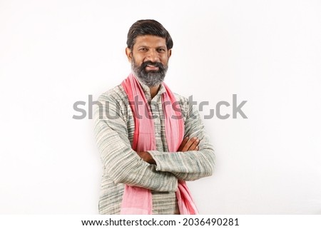 Portrait of an happy Indian bearded man in rural India concept. Funky expressions white background.  Royalty-Free Stock Photo #2036490281