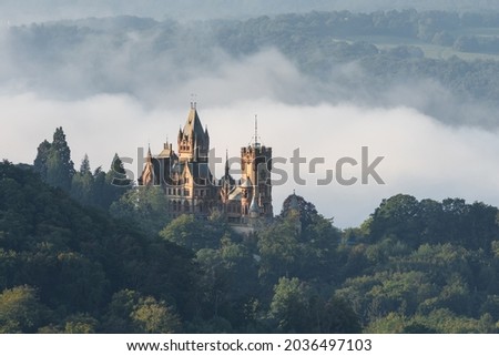 Autumn fog in Nature Park Siebengebirge (Seven Mountains) arose from the river Rhine valley, view of an old castle, NRW, Germany 