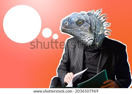 Businessman with lizard face.  head of reptile symbolizes aggressive character.  concept is aggressive behavior in business. Businessman on red background. Aggressive businessman with dialog cloud