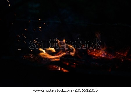 flames and sparks of fire at night Royalty-Free Stock Photo #2036512355